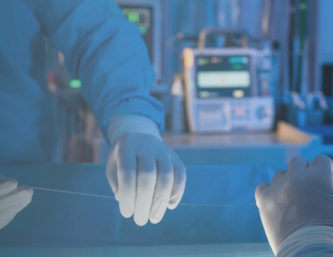 A hand with surgical gloves on it